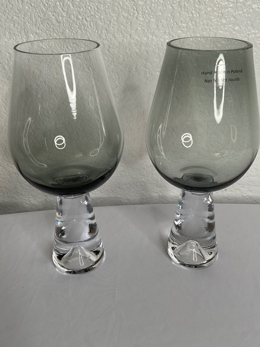 Tank wine glasses feature a distinctive smoke-tinted bowl mouth-blown in Poland.